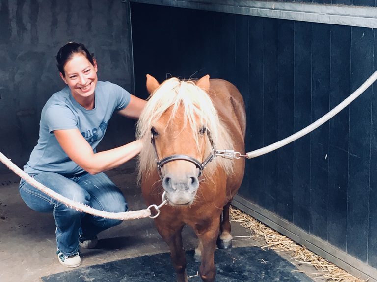 Woman posing with horse