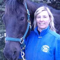 Sue Ross, MMCP A woman smiling with a horse.