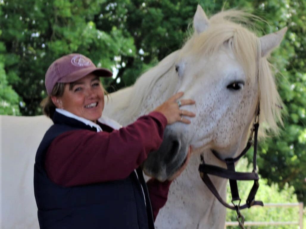 A woman working with a horse.