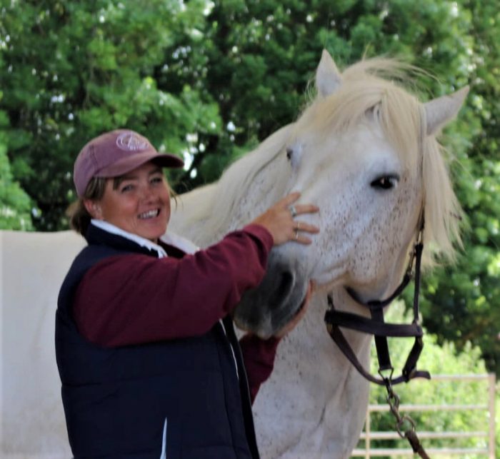 Vicky Devlin & White Horse 2 A woman working with a horse.
