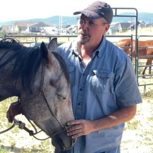 man softly touching horse