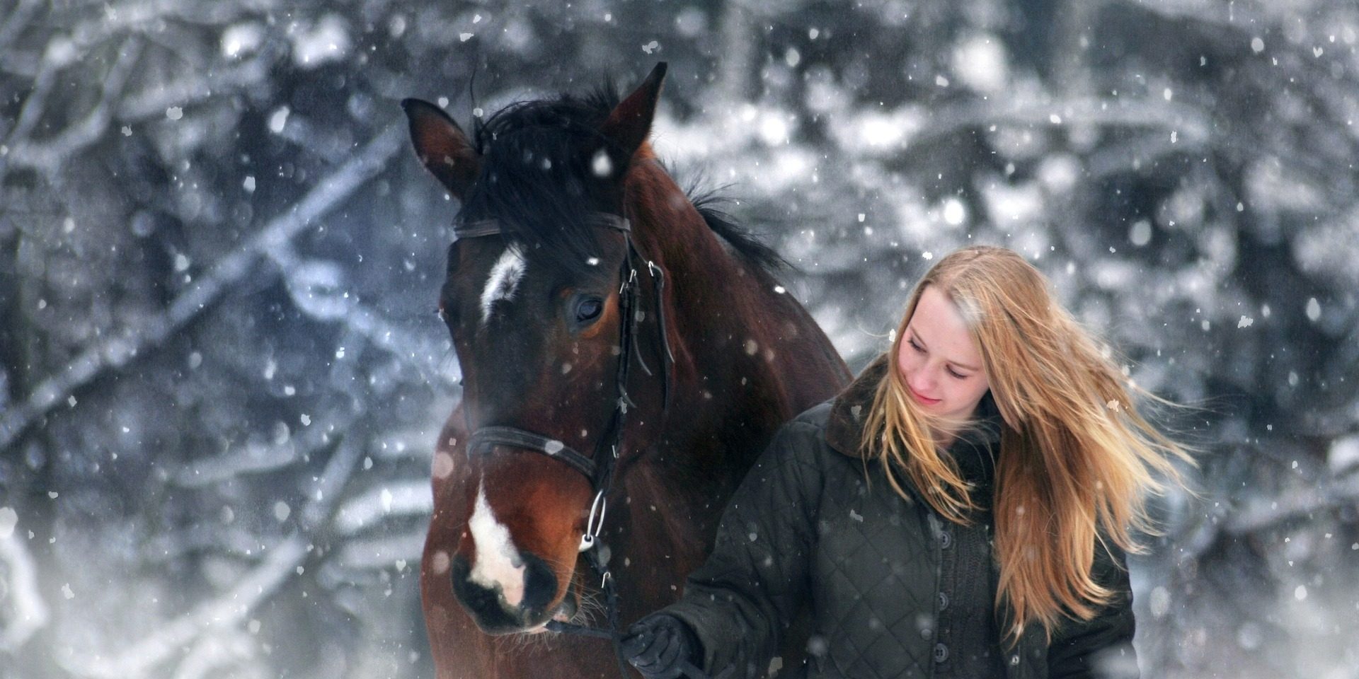 woman and horse in winter snow