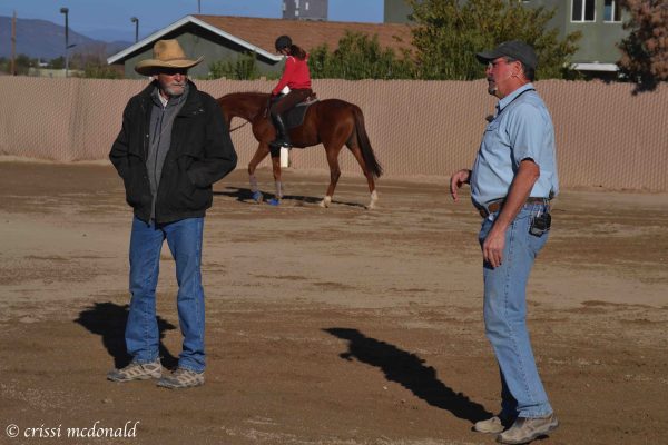 Mark Rashid and Jim Masterson working with a horse and rider.