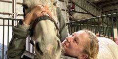 A woman working with a horse.