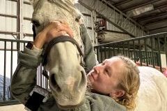 A woman working with a horse.