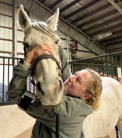 Laura Grant MMCP A woman working with a horse.