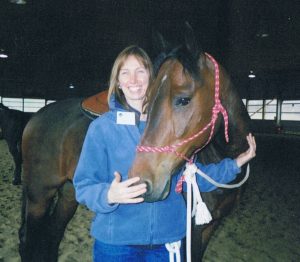 Photo of Christine Akey Snider with a horse.