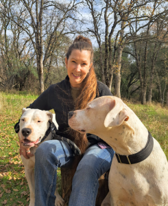 Kalin Finsand, MMCP Equine, NBCAAM, with 2 dogs.
