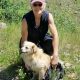 woman and dog near mountain.