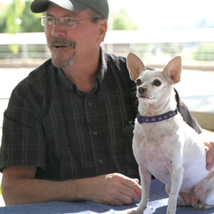 man holding white dog