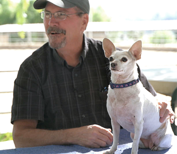 man holding white dog