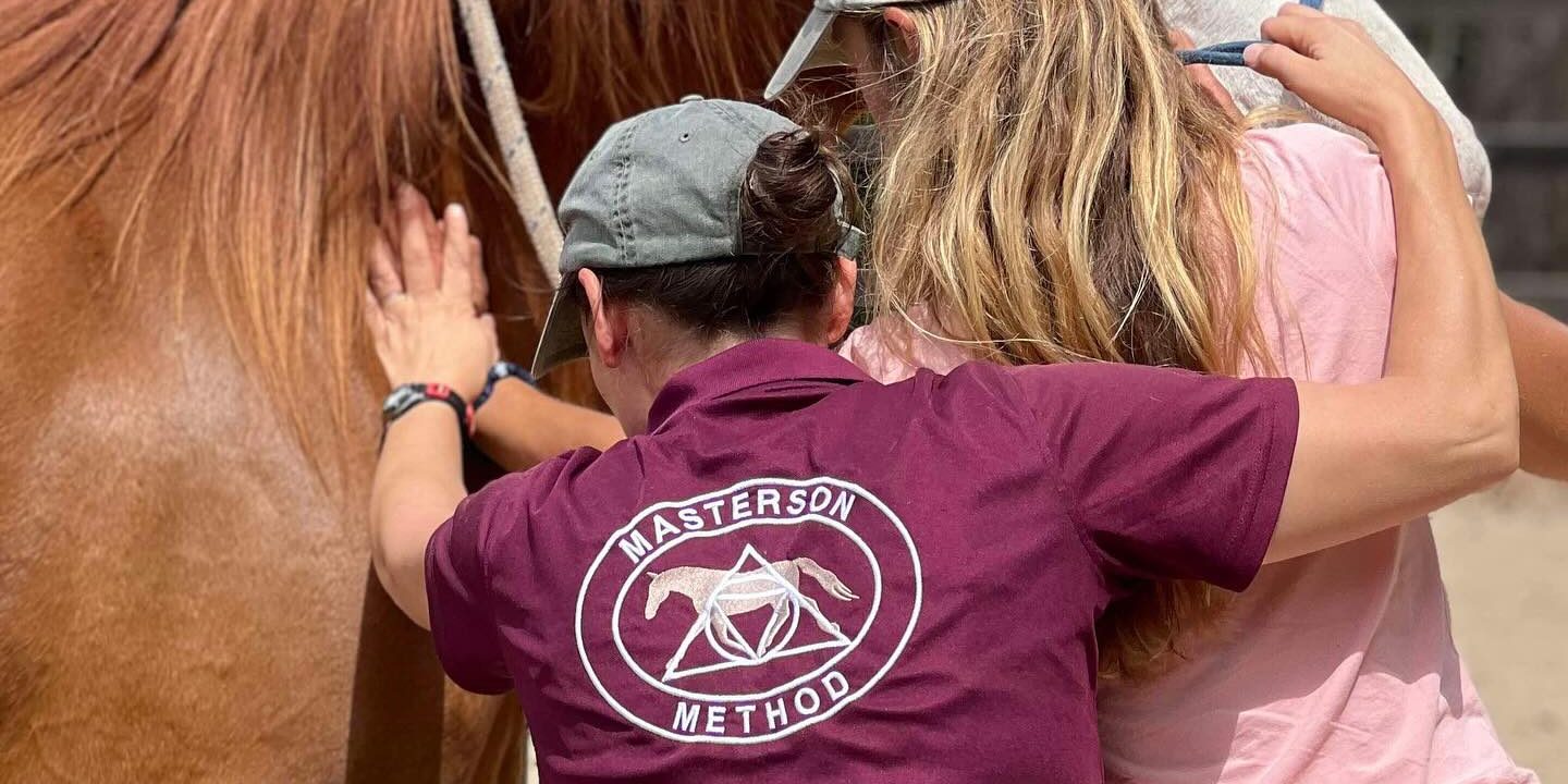 Instructor Teaching Under the Scapula Technique Instructor teaching a student how to do a Masterson Method technique with hands-on assistance.