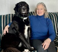A woman sitting with her dog.