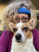 A woman hiding behind a dog!