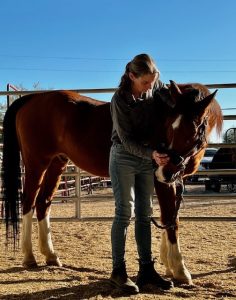 A woman working with a horse.