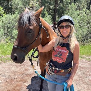 A woman standing with a horse.