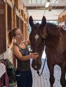 A woman working with a horse.