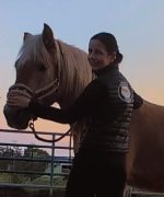A woman working with her horse.