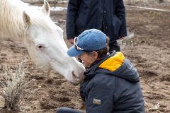 A woman working with a horse.