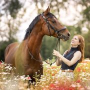 A woman smilling at her horse.