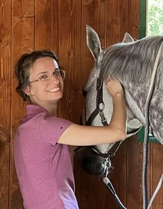A woman working with a horse.