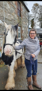A woman standing with a horse.