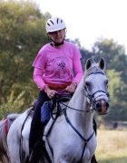Kathy Burnett MMCP A woman riding her horse.