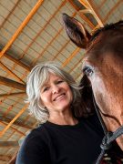 Michelle Fobian MMCP A woman smiling with her horse.