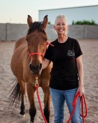 Renee Martinson MMCP A woman standing with her horse.
