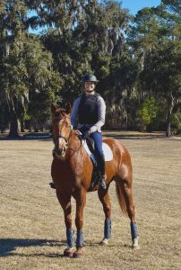 A woman riding her horse.