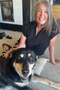 Monica Goold MMCP Canine A woman smiling, with her dog.