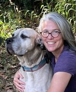 Shannon McBride MMCP Canine A woman, smiling, with her dog.
