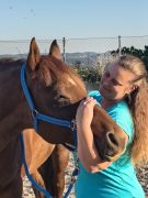 A woman working with a horse.