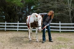 A woman working with a horse.